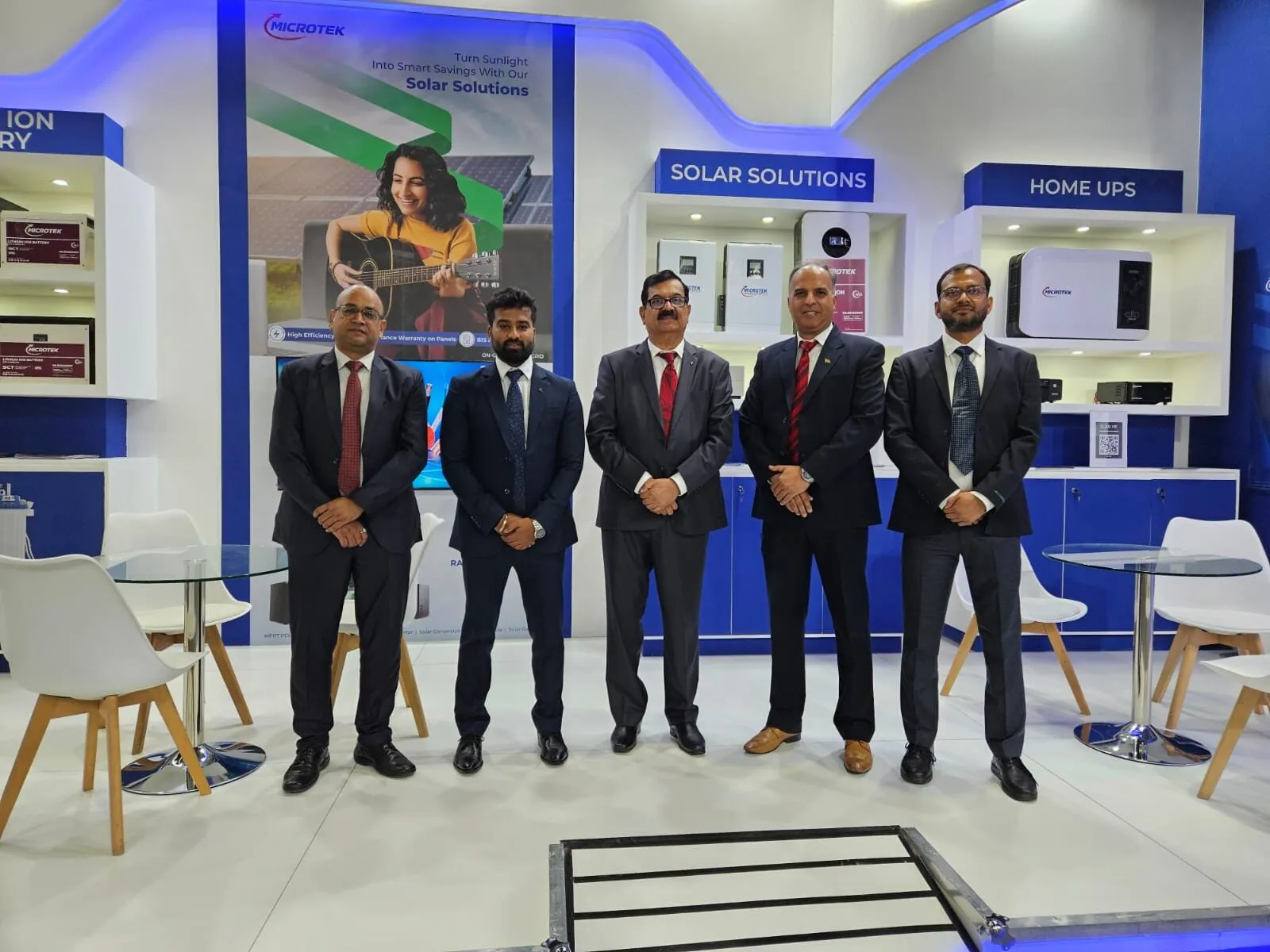 Microtek leadership at the company's Dubai trade-show booth, with Solar Solutions and Home UPS product lines on display