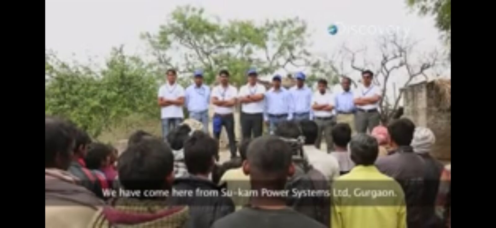 Su-Kam team in branded uniforms addressing villagers during the Sun Fuel feature