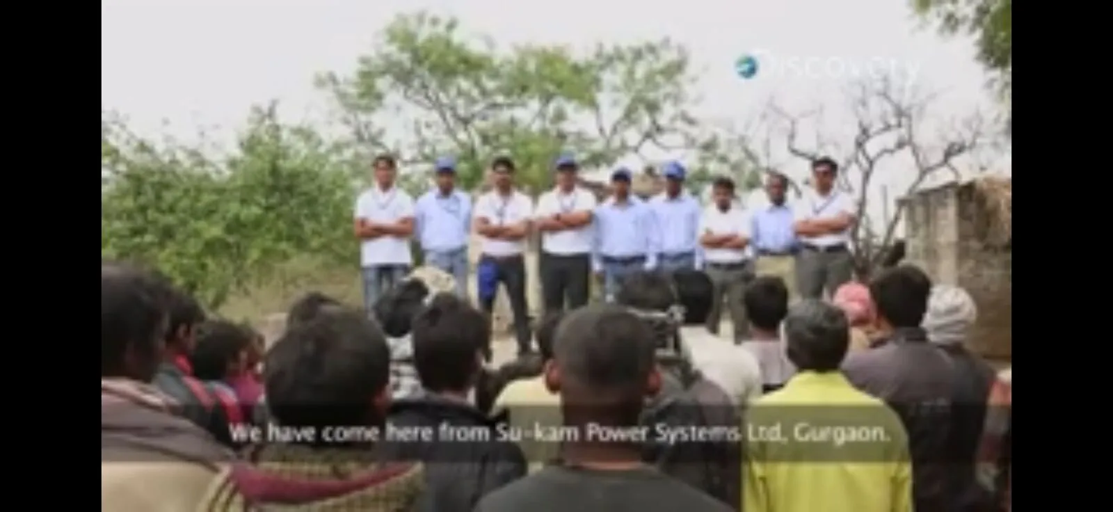 Su-Kam team in branded uniforms addressing villagers during the Sun Fuel feature