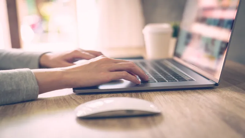 A person rebuilding at a laptop — a portrait of starting over