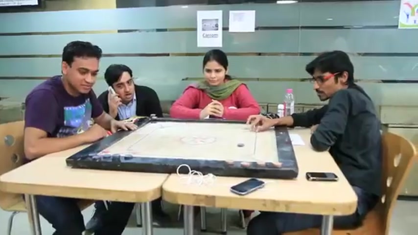 Carrom match between four Su-Kam employees at the office during Sports Day