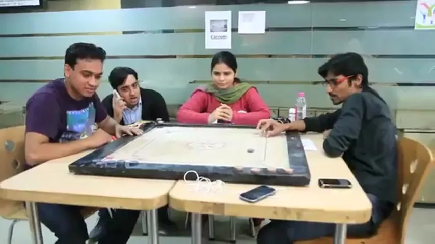 Carrom match between four Su-Kam employees at the office during Sports Day