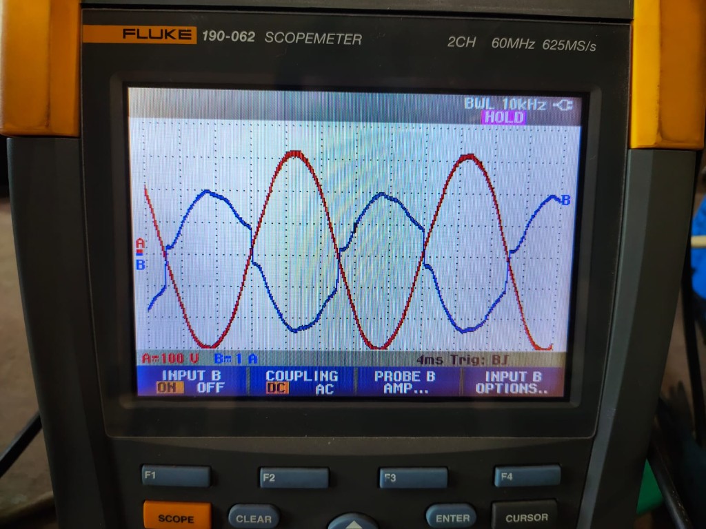 Fluke scopemeter — pure sine wave (red) vs distorted output (blue), the demonstration Kunwer showed dealers