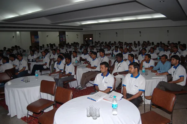 A hall full of Su-Kam service engineers in company uniform attending a training session